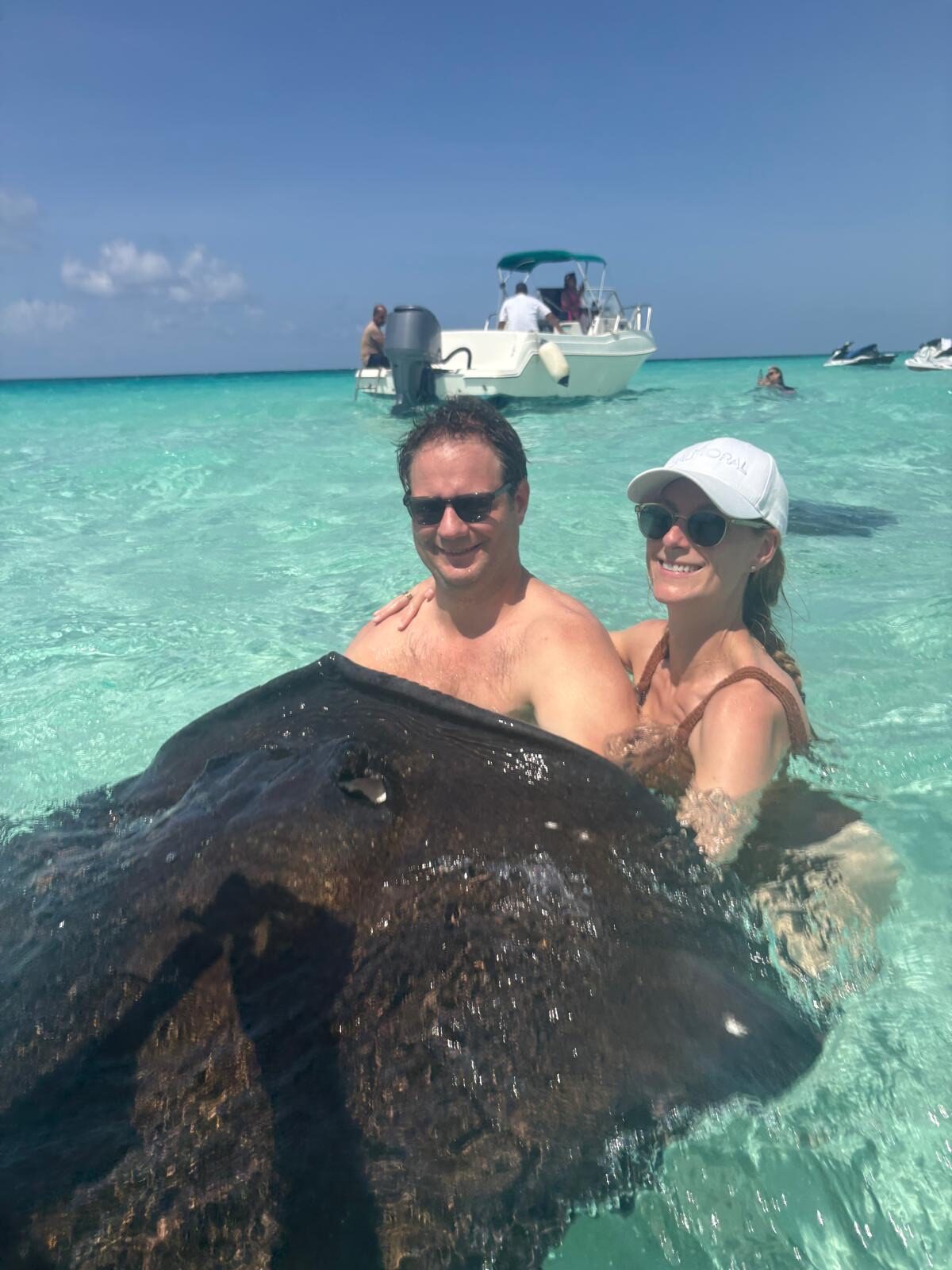 Phoebe and Chris swimming with a stingray in the Caribbean