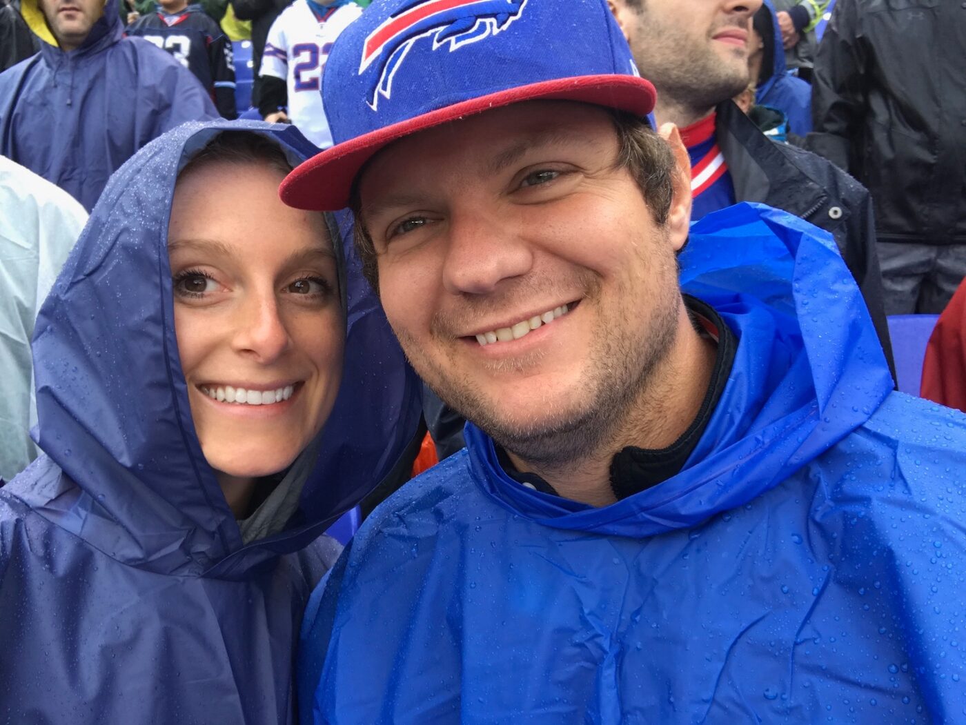 Phoebe and Chris in ponchos at a rainy Bills game